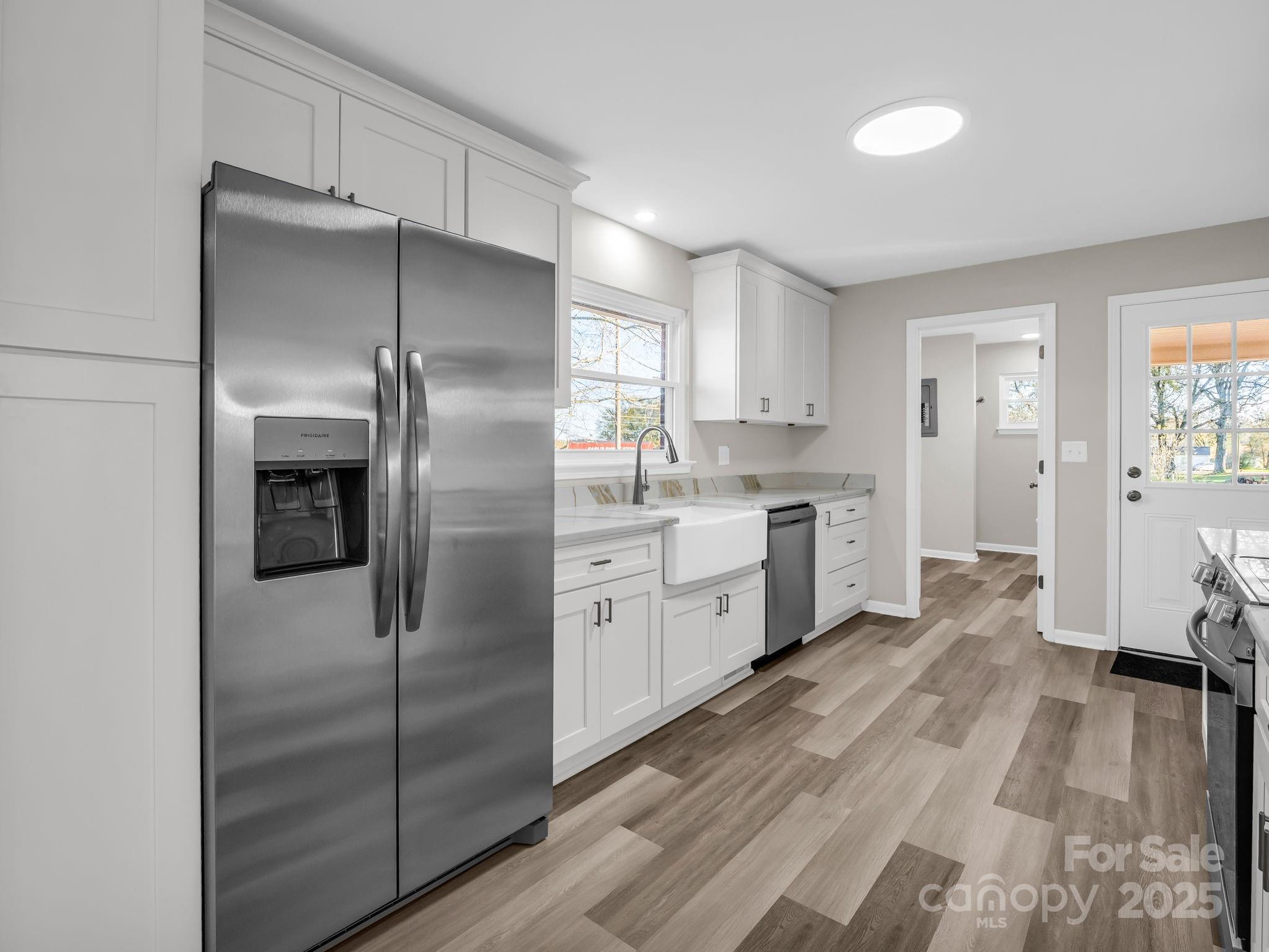 1696 Race Path Church Road Mooresboro, NC 28114 - Photo 10 of 31 a kitchen with a refrigerator a sink and dishwasher with wooden floor
