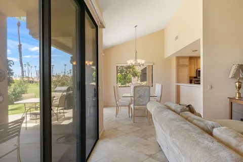 a living room with a large window and furniture