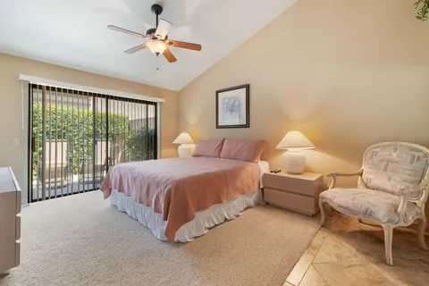 a spacious bedroom with a bed and a chair