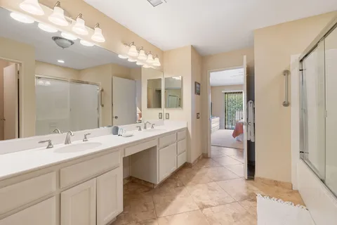 a large bathroom with a double vanity sink mirror and double