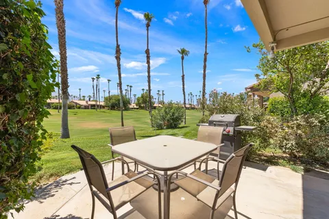a view of a chairs with a table in the patio