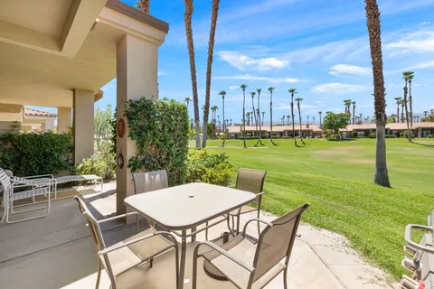 a view of an chairs and table in the patio