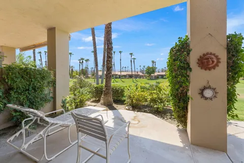 a view of a patio with table and chairs and potted plants
