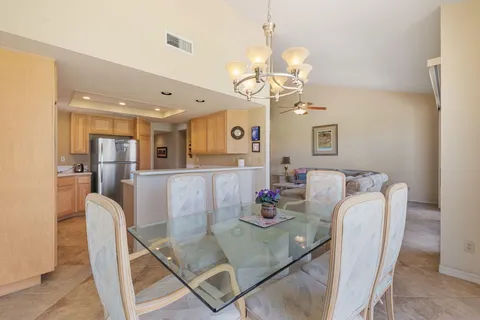 a view of a dining room with furniture and a chandelier