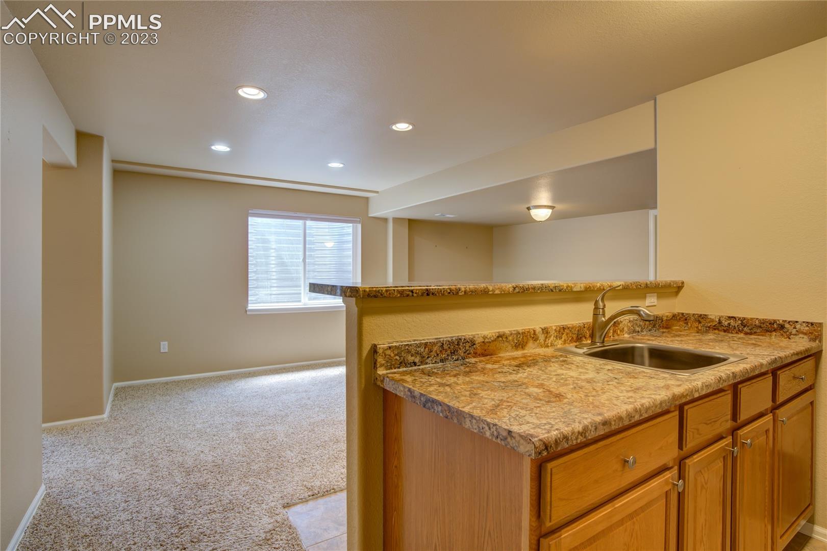 7730 Midnight Road Peyton, CO 80831 - Photo 27 of 50 Basement living room and wet bar
