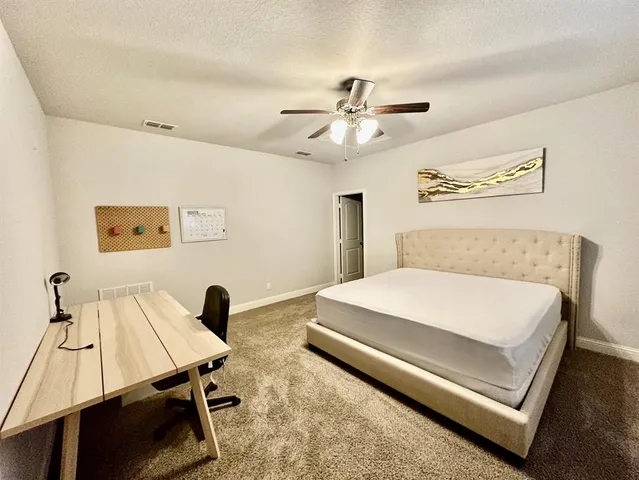 a bedroom with a bed and a table