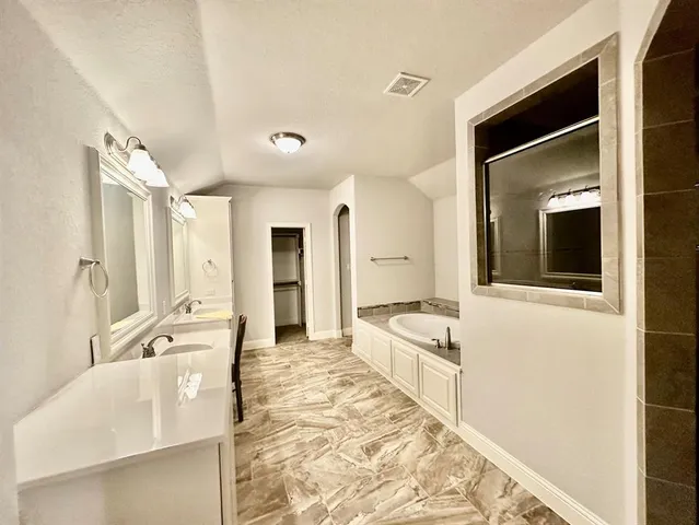 a large white kitchen with a large window