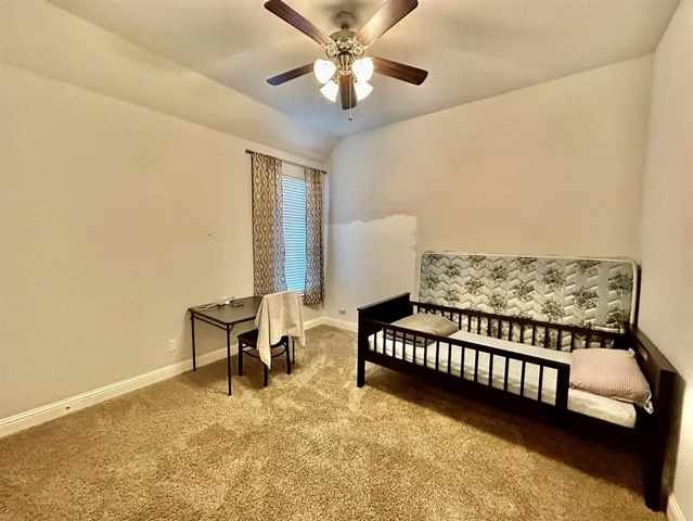 a view of a room with furniture and ceiling fan