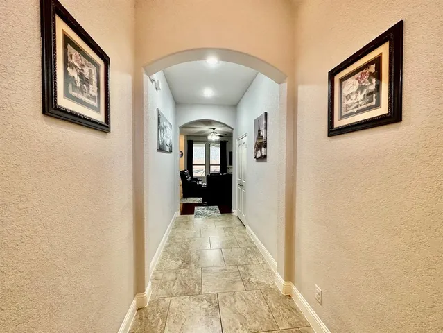 a view of a hallway with paintings on the wall
