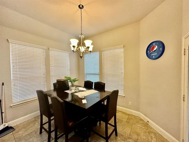 a view of a dining room with furniture and chandelier
