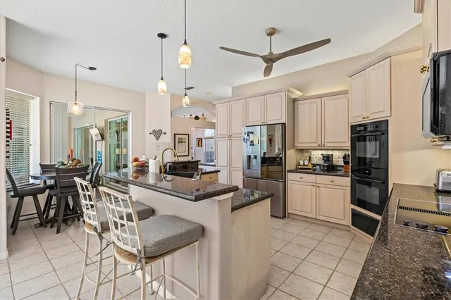a living room with furniture a fireplace and floor to ceiling windows