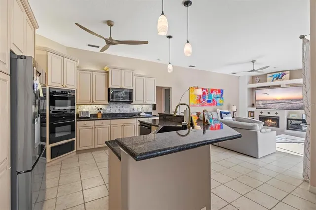 a bedroom with a large bed and a flat tv screen on dresser