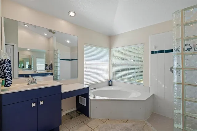 a view of green field with trees in the background