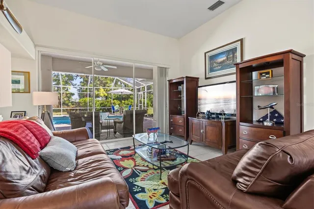 a kitchen with granite countertop a sink and a white cabinets