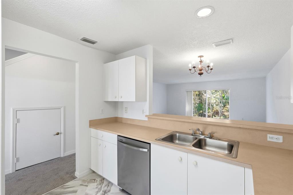 1502 Deer Springs Road Port Orange, FL 32129 - Photo 11 of 35 a kitchen with a sink cabinets and a window