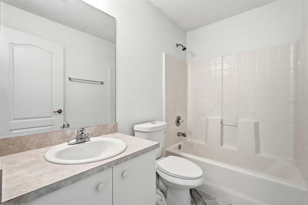 1502 Deer Springs Road Port Orange, FL 32129 - Photo 23 of 35 a bathroom with a sink toilet a mirror and shower