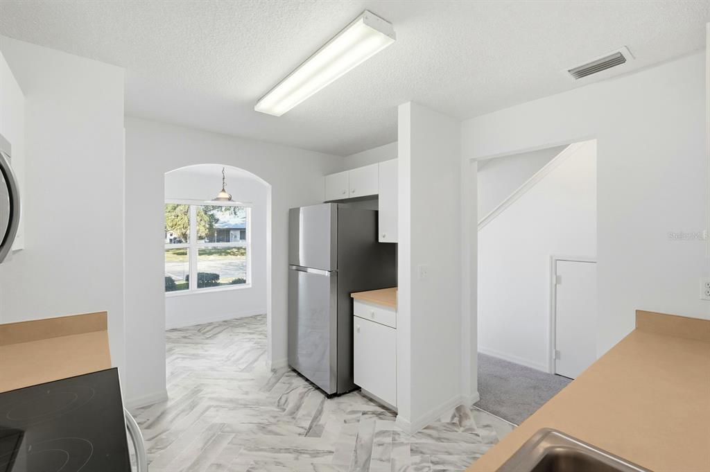 1502 Deer Springs Road Port Orange, FL 32129 - Photo 10 of 35 a view of a kitchen with refrigerator and window