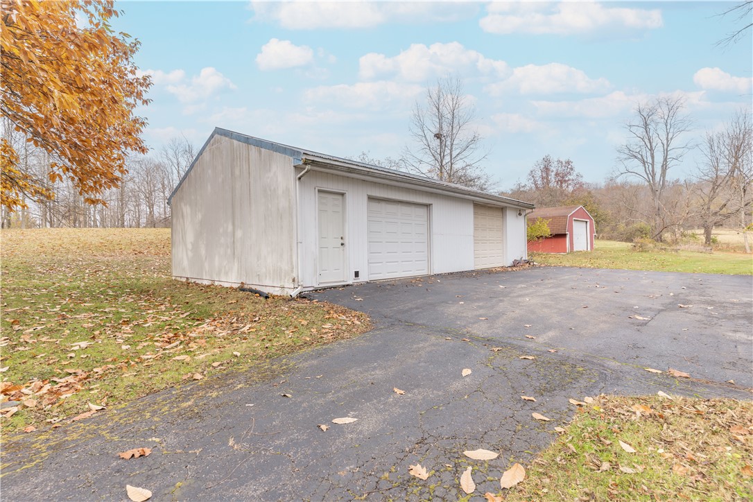 18333 Lefevre Number 2 Road Sidney, OH 45365 - Photo 17 of 25 This property features a spacious garage and shed, providing ample storage and utility.