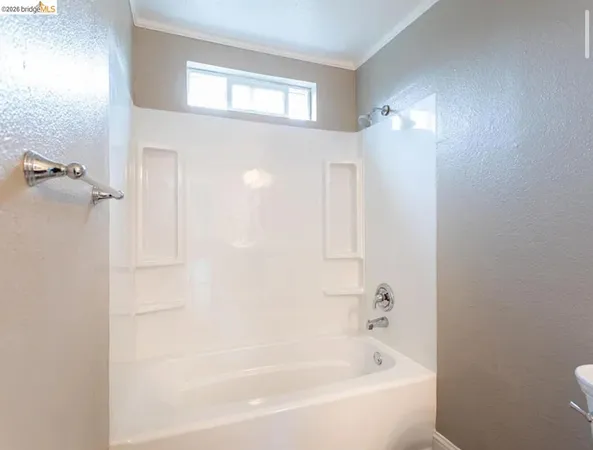 a white bath tub sitting next to a white sink