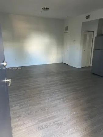 an empty room with wooden floor