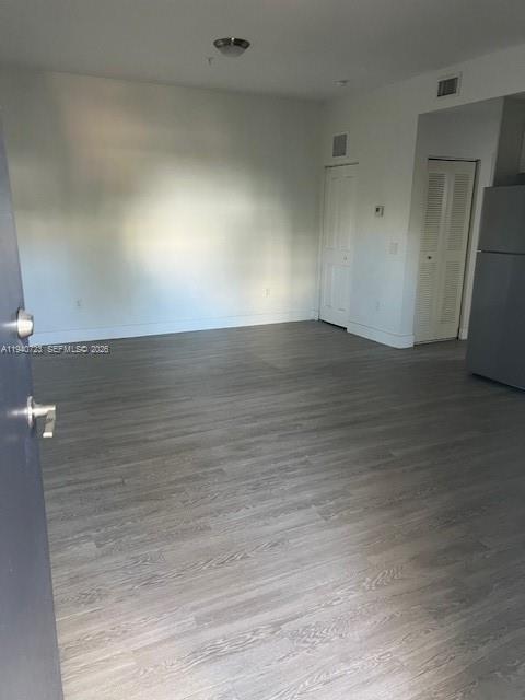 751 Northwest 1st Street, Unit 103 Miami, FL 33128 - Photo 5 of 11 an empty room with wooden floor
