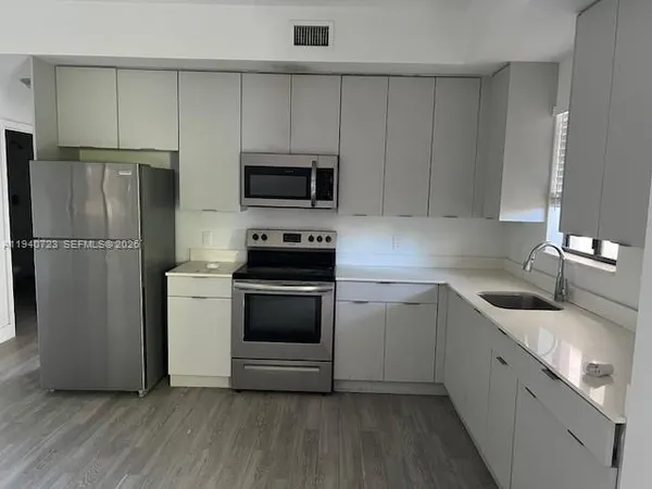 a kitchen with a sink and steel stainless steel appliances