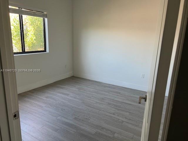 751 Northwest 1st Street, Unit 103 Miami, FL 33128 - Photo 7 of 11 an empty room with windows
