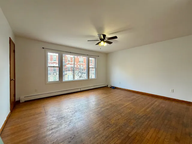 wooden floor in an empty room with a window