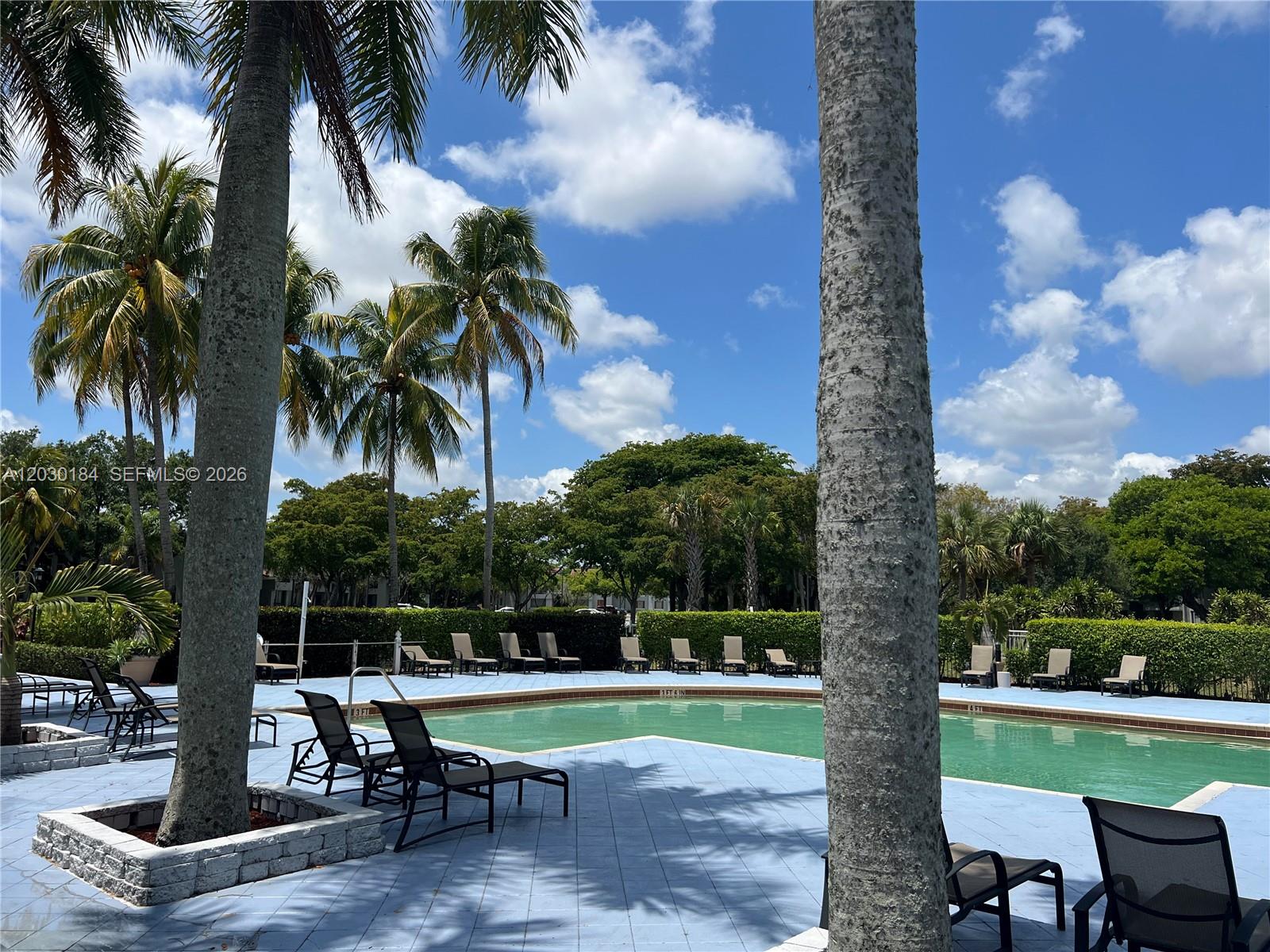 951 Lyons Road, Unit 6104 Coconut Creek, FL 33063 - Photo 15 of 18 a view of a sitting area with swimming pool and sitting area