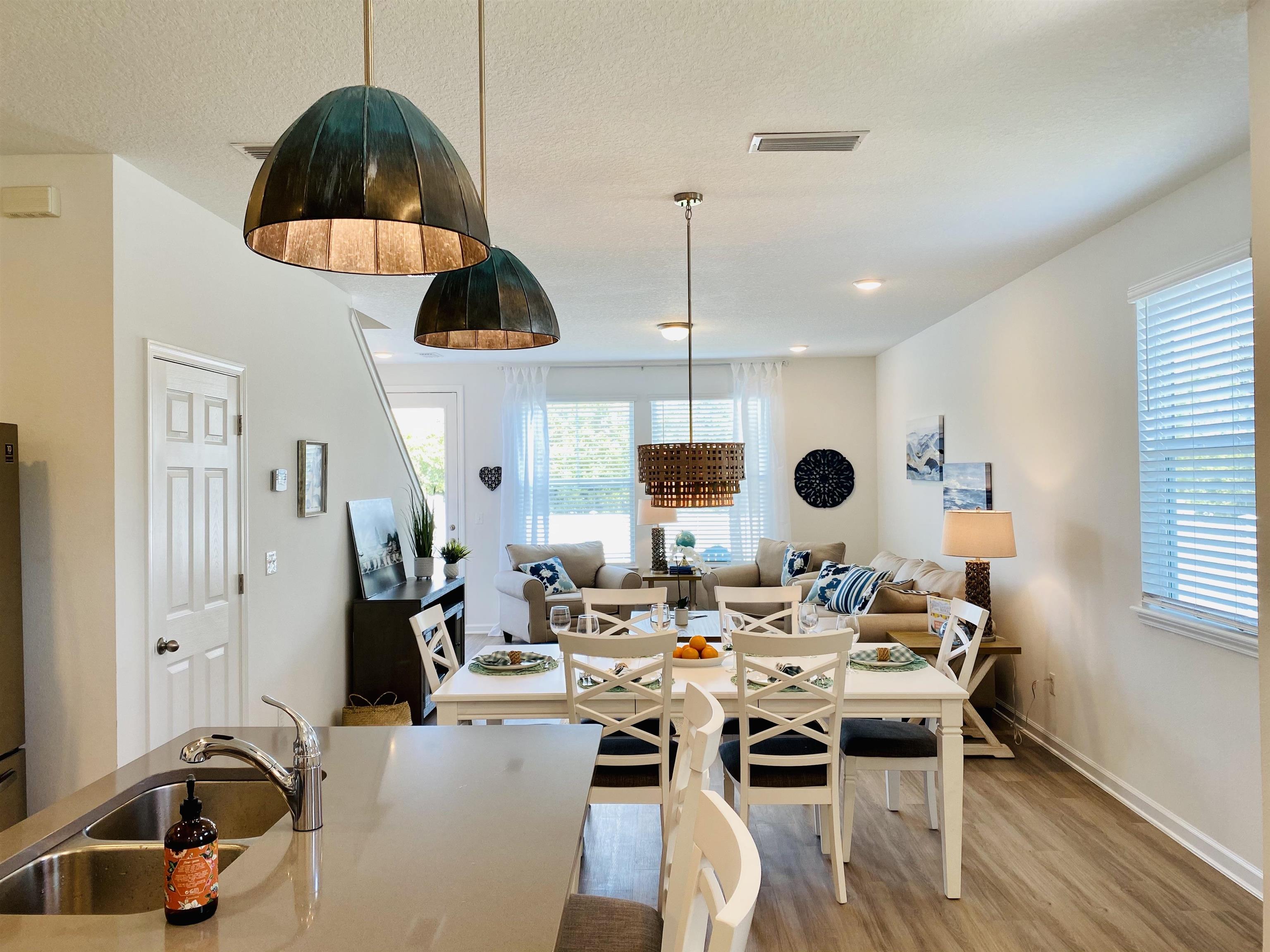 58 Ridge Lake Rd Street St. Augustine, FL 32086 - Photo 3 of 23 a dining room with stainless steel appliances kitchen island a table and chairs in it
