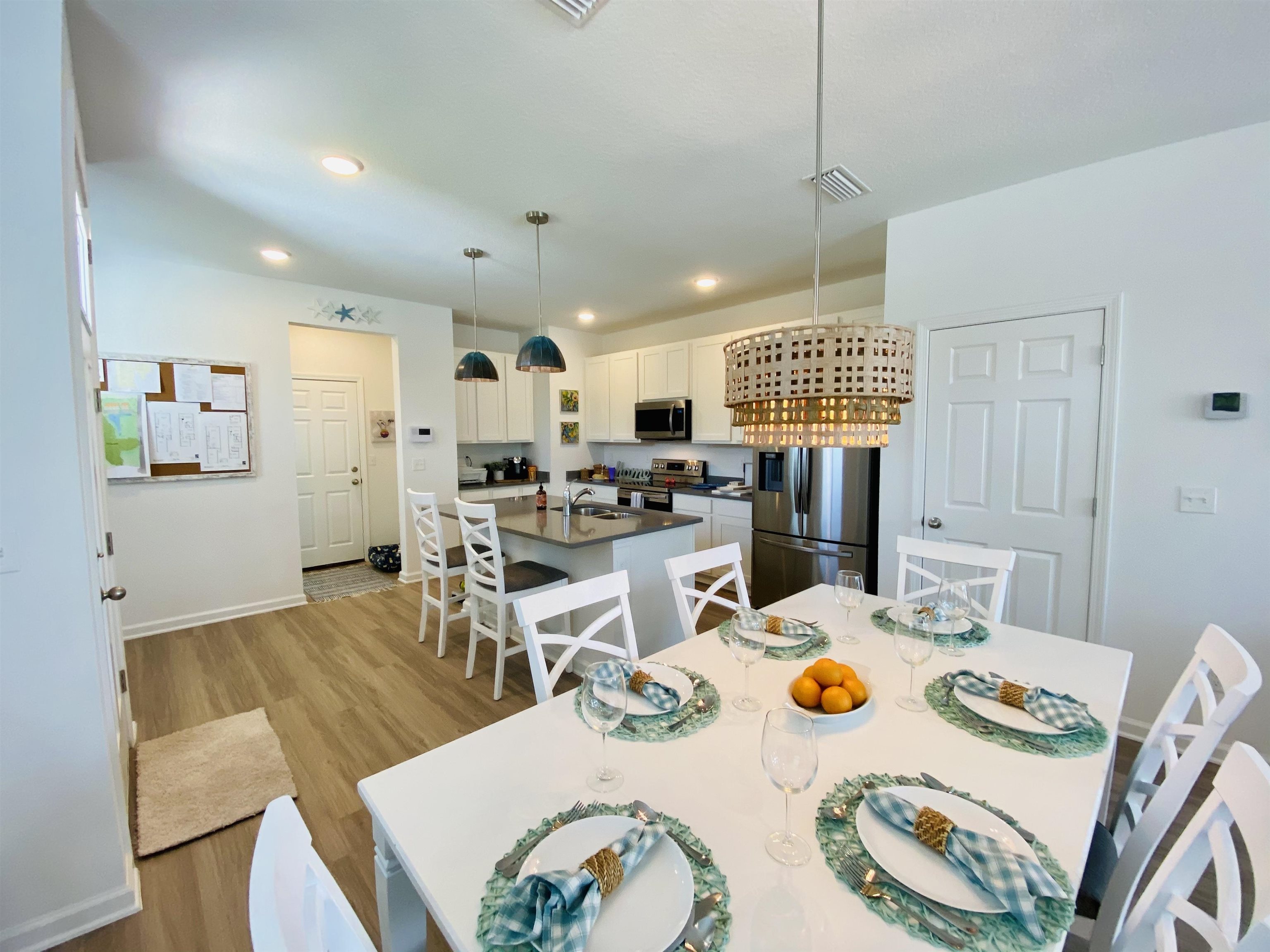 58 Ridge Lake Rd Street St. Augustine, FL 32086 - Photo 21 of 23 a open dining room with stainless steel appliances a table and chairs