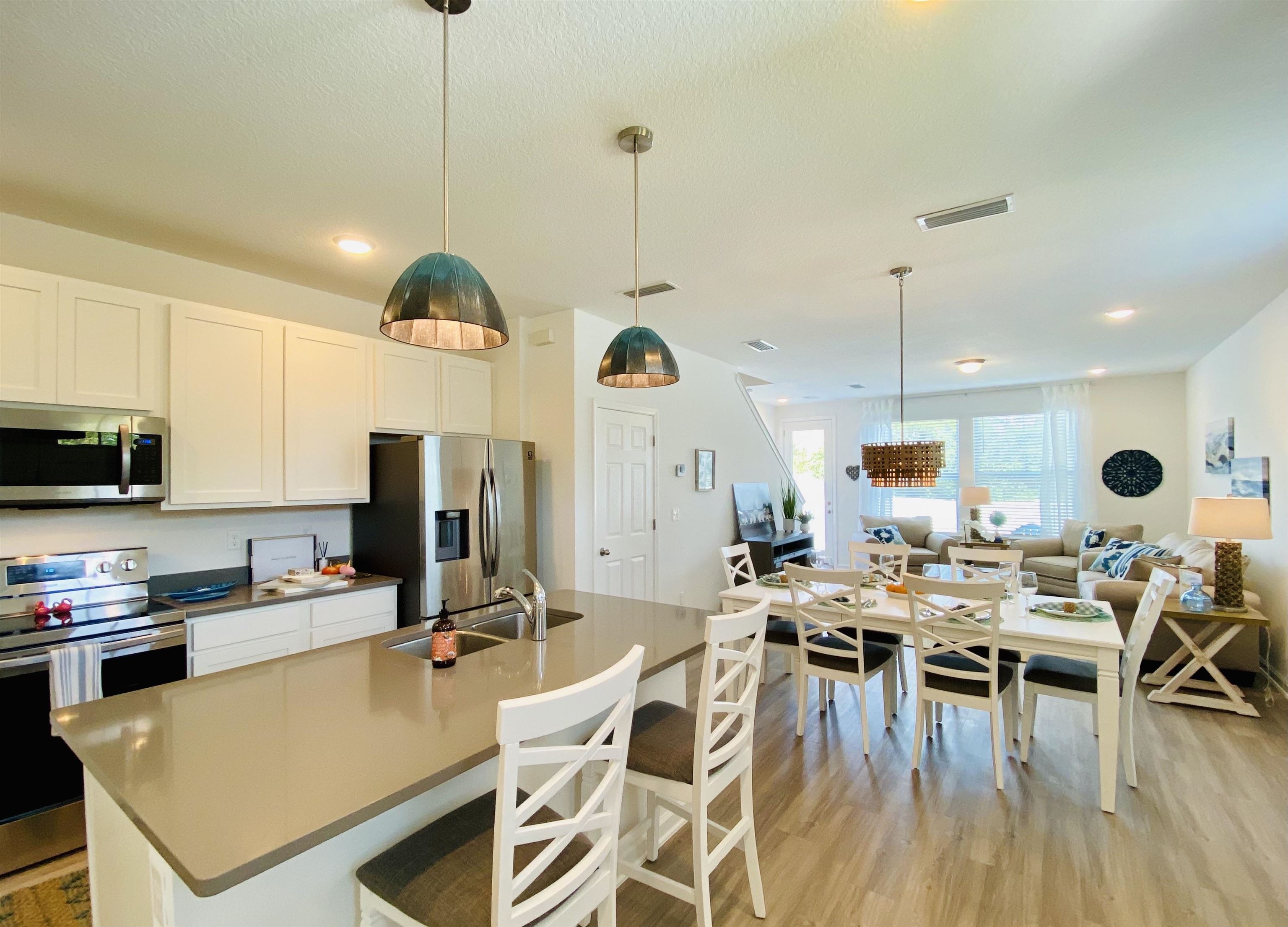 58 Ridge Lake Rd Street St. Augustine, FL 32086 - Photo 4 of 23 a large kitchen with a table and chairs