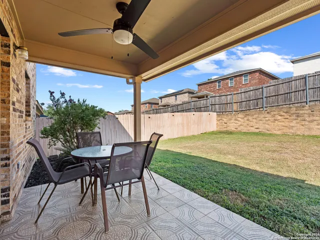 a view of a patio with a table and chairs