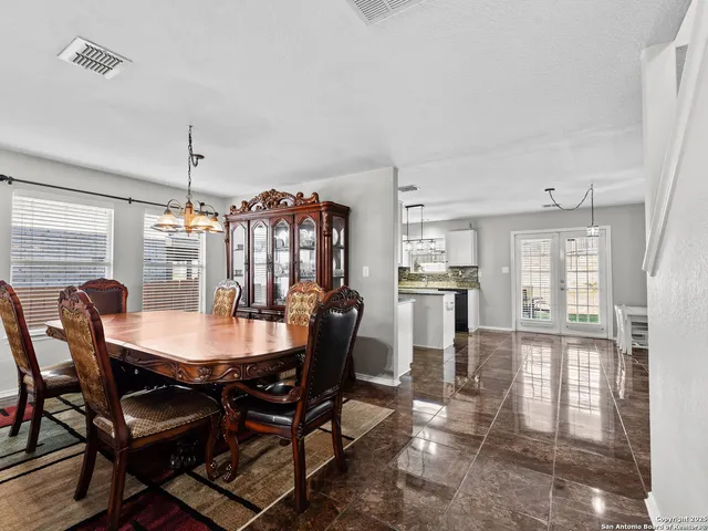 a dining room with furniture and window