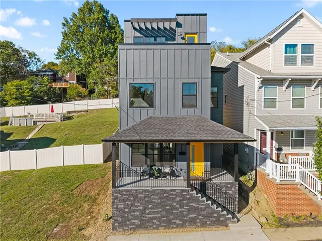 a view of a house with a yard and sitting area
