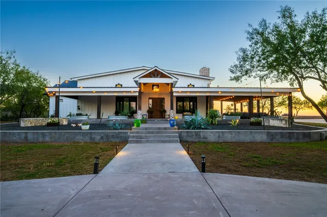 a front view of a house with a yard table and chairs