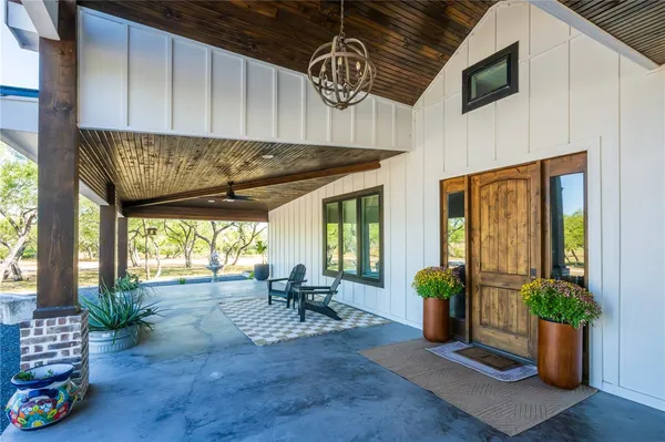 a view of outdoor seating space with furniture window and wooden floor