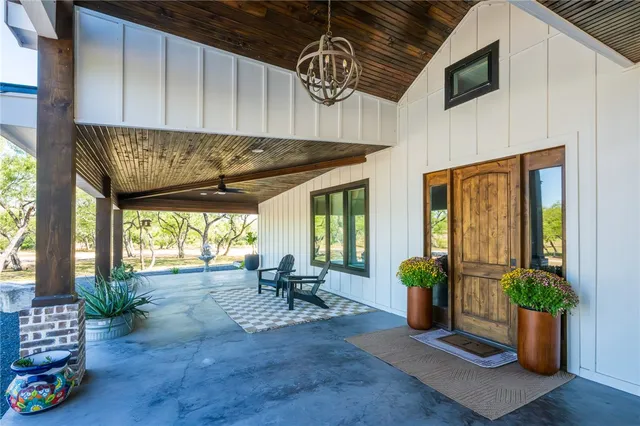 a view of outdoor seating space with furniture window and wooden floor