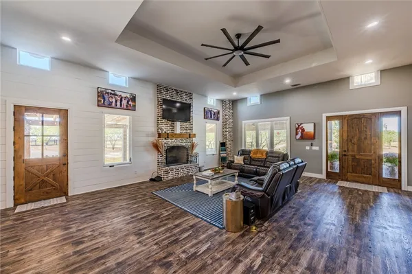 a living room with furniture and wooden floor