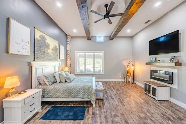 a bedroom with furniture and a flat screen tv