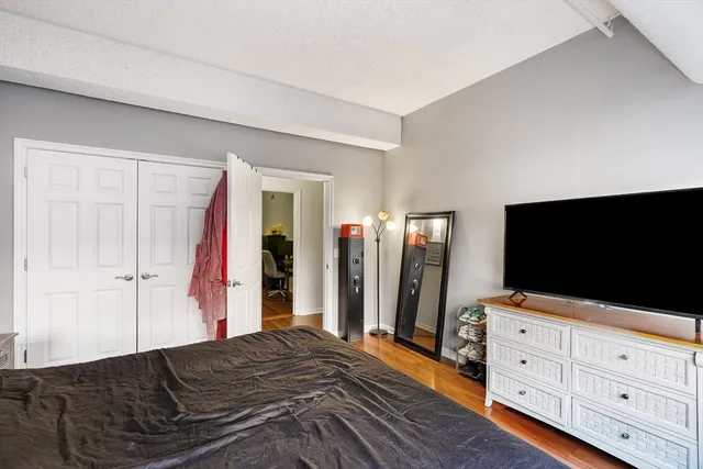 a bedroom with a bed and a flat screen tv