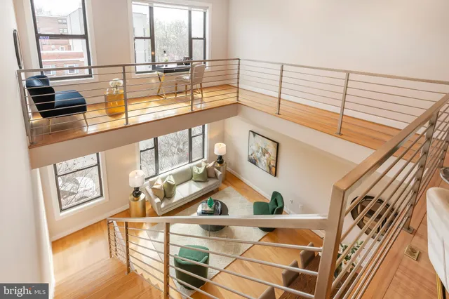 a view of a living room with furniture and floor to ceiling windows