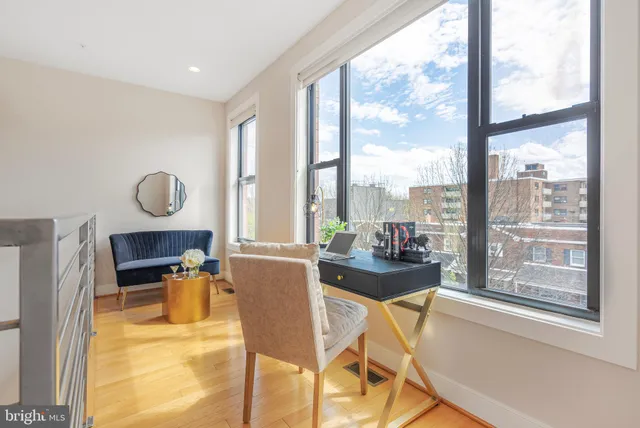 a living room with furniture and a mirror