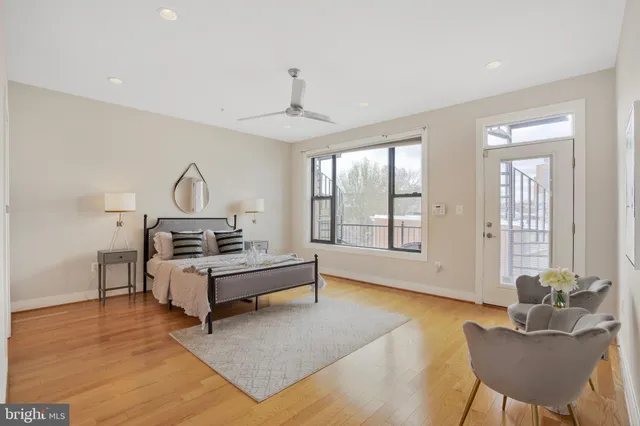 a bedroom with a bed and windows