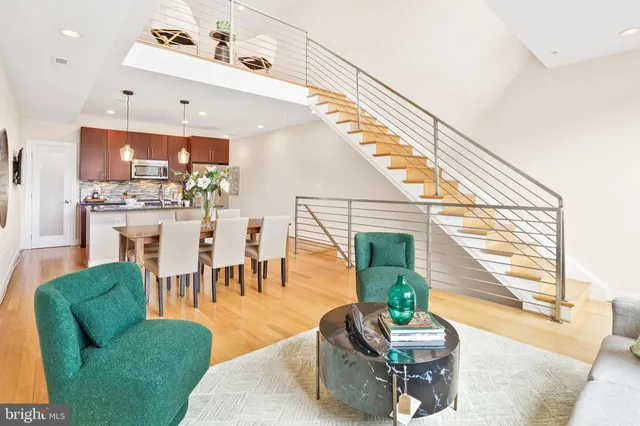 a living room with fireplace furniture and a large window