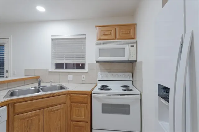 a kitchen with a stove cabinets and sink