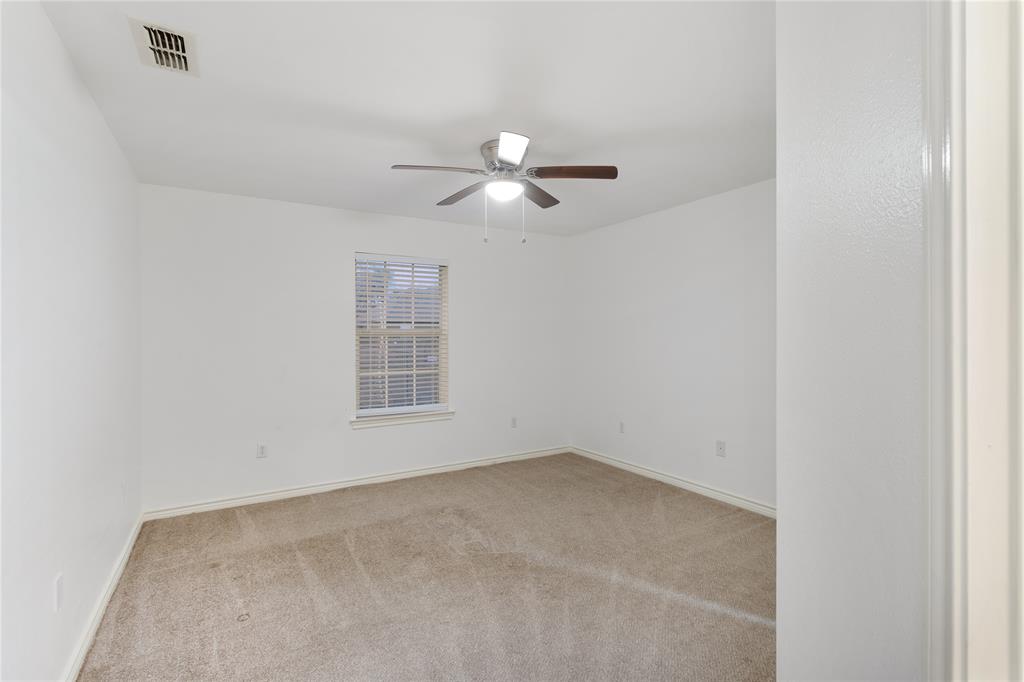 1021 Rice Street, Unit 102 Denison, TX 75020 - Photo 12 of 18 a view of a room with a ceiling fan and a window