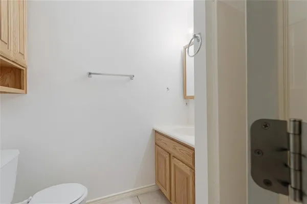 a bathroom with a granite countertop toilet and a shower