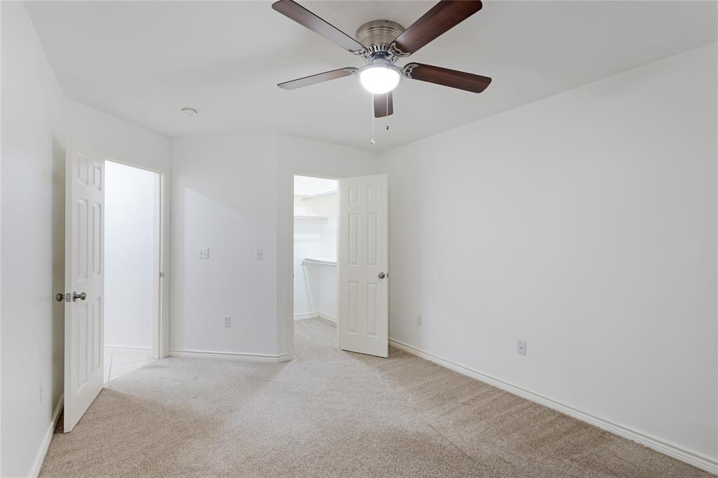 1021 Rice Street, Unit 102 Denison, TX 75020 - Photo 16 of 18 an empty room with chandelier fan