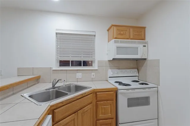 a kitchen with a sink and cabinets